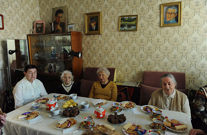 elderly family sitting around table