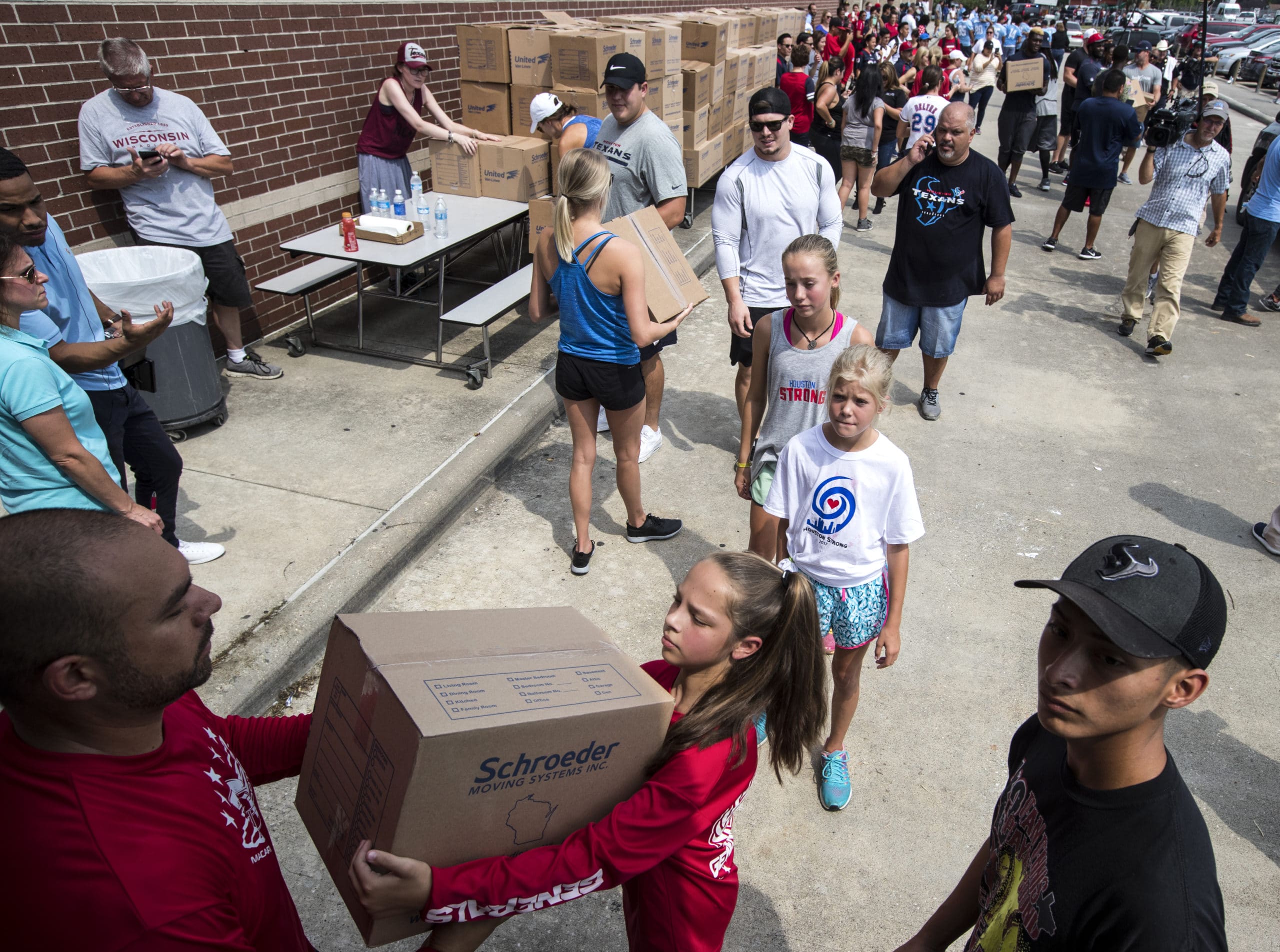 volunteers carrying boxes of supplies