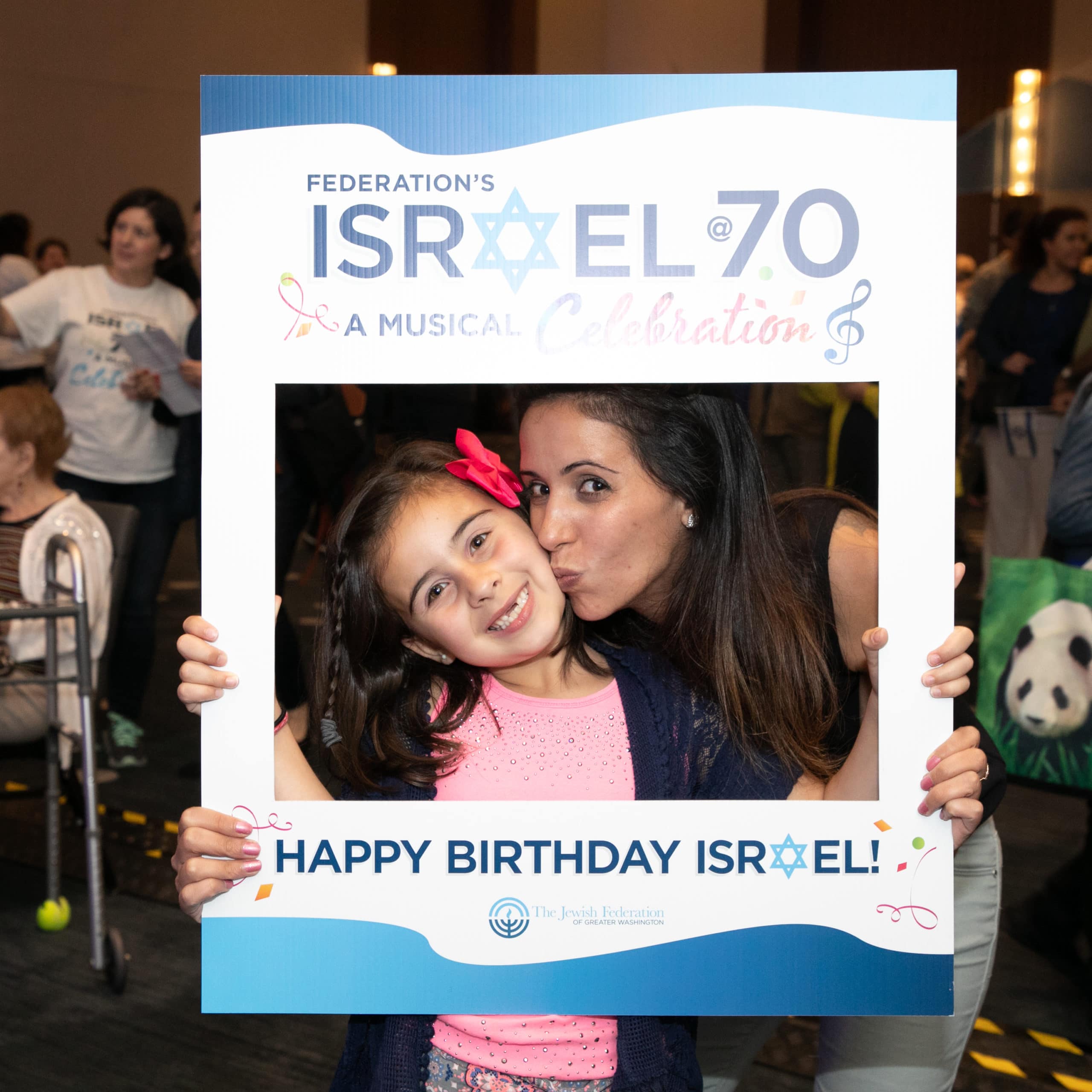 mom and daughter posing with Israel@70 cutout frame