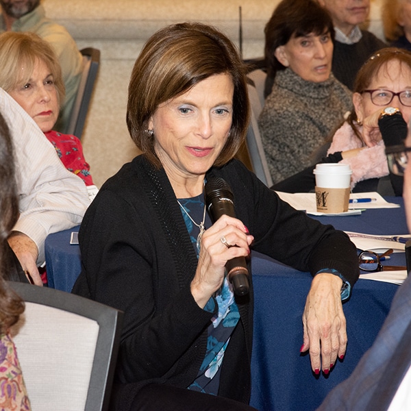Woman with microphone at a Women's Leadership event