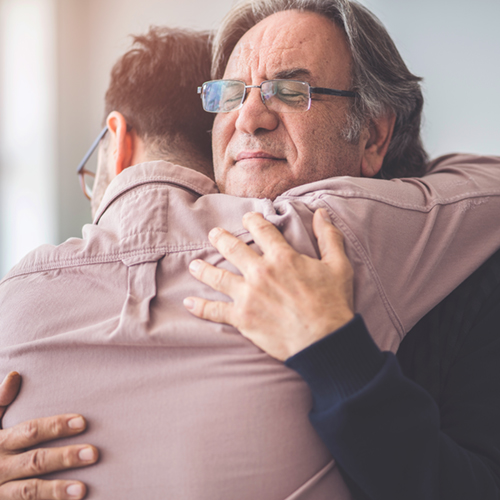 hugging-isto995420532-saturated_500x500px Closeup of two men hugging