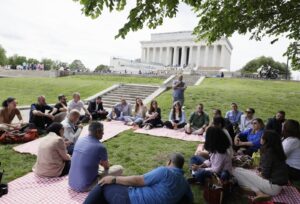 people sitting by the Lincoln Memorial in DC