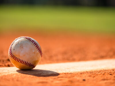 Baseball with dirt on it sitting atop pitchers mound close up