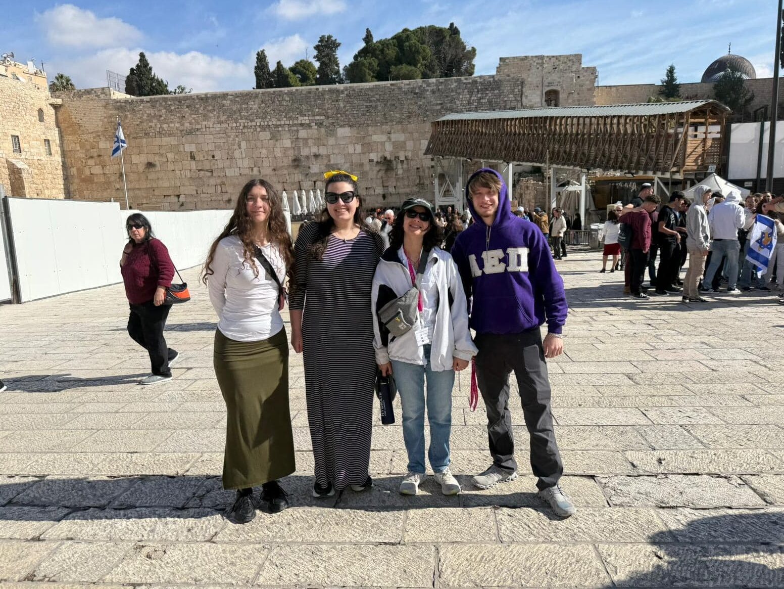Four young adults standing at the Western Wall