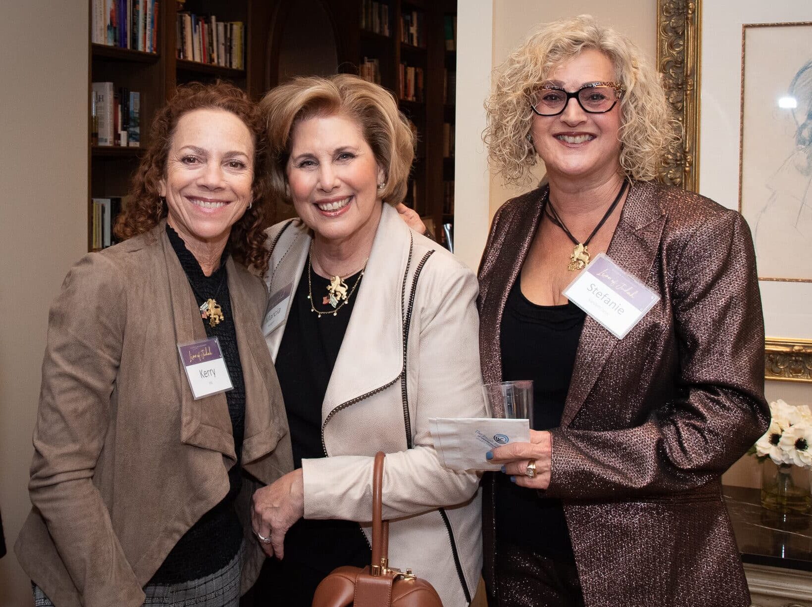 Three women wearing Lion of Judah pins