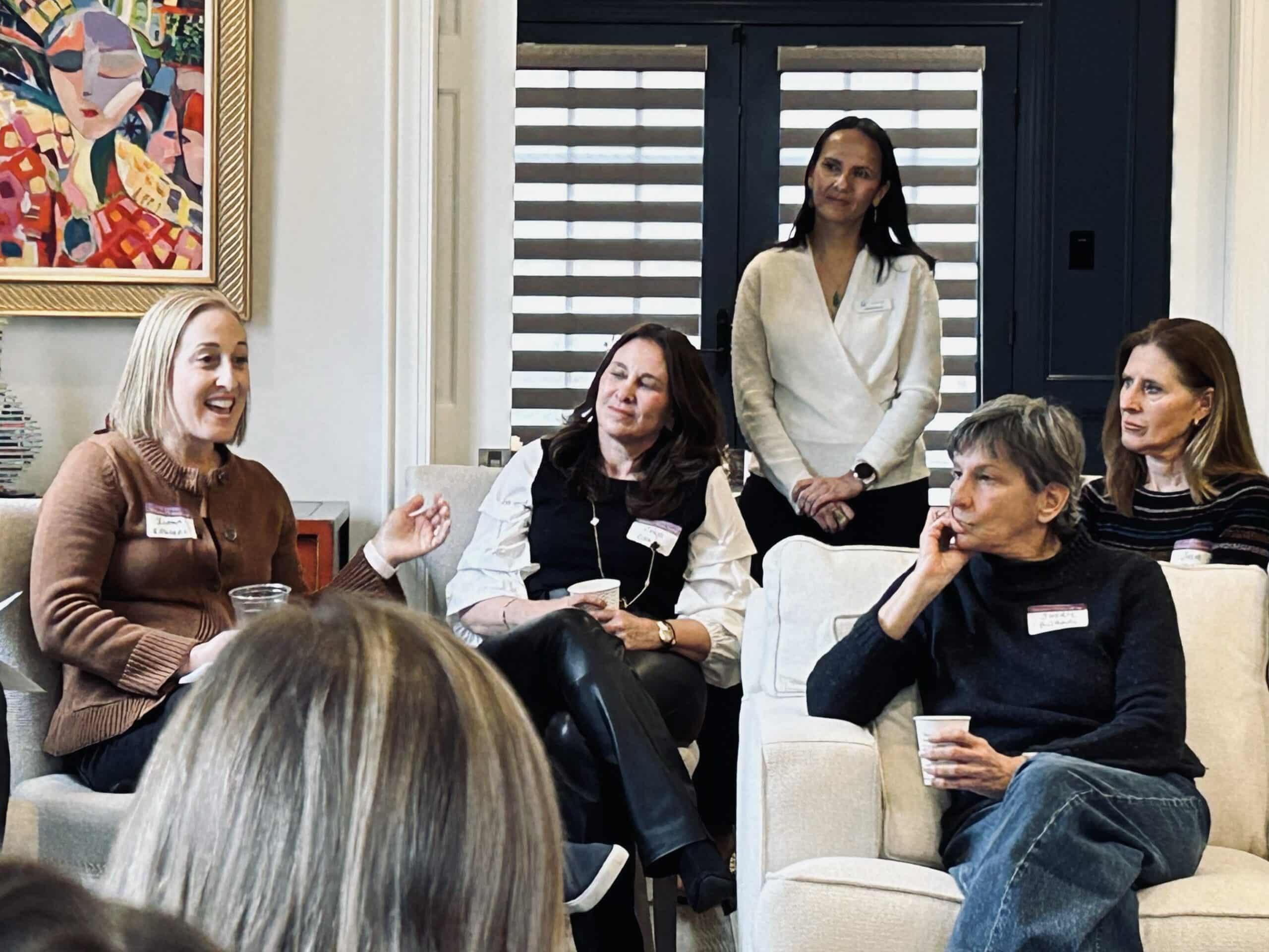 A group of women mostly seated at a Women's Philanthropy event