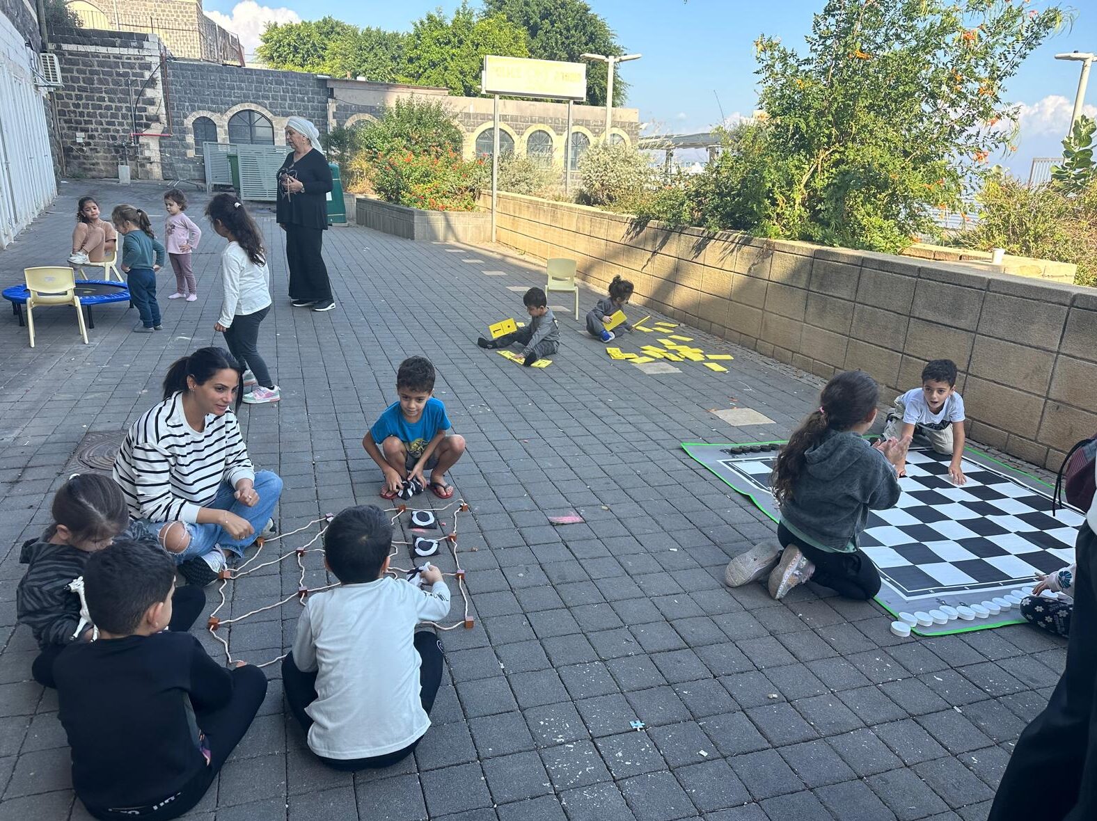 Children playing various games in a courtyard