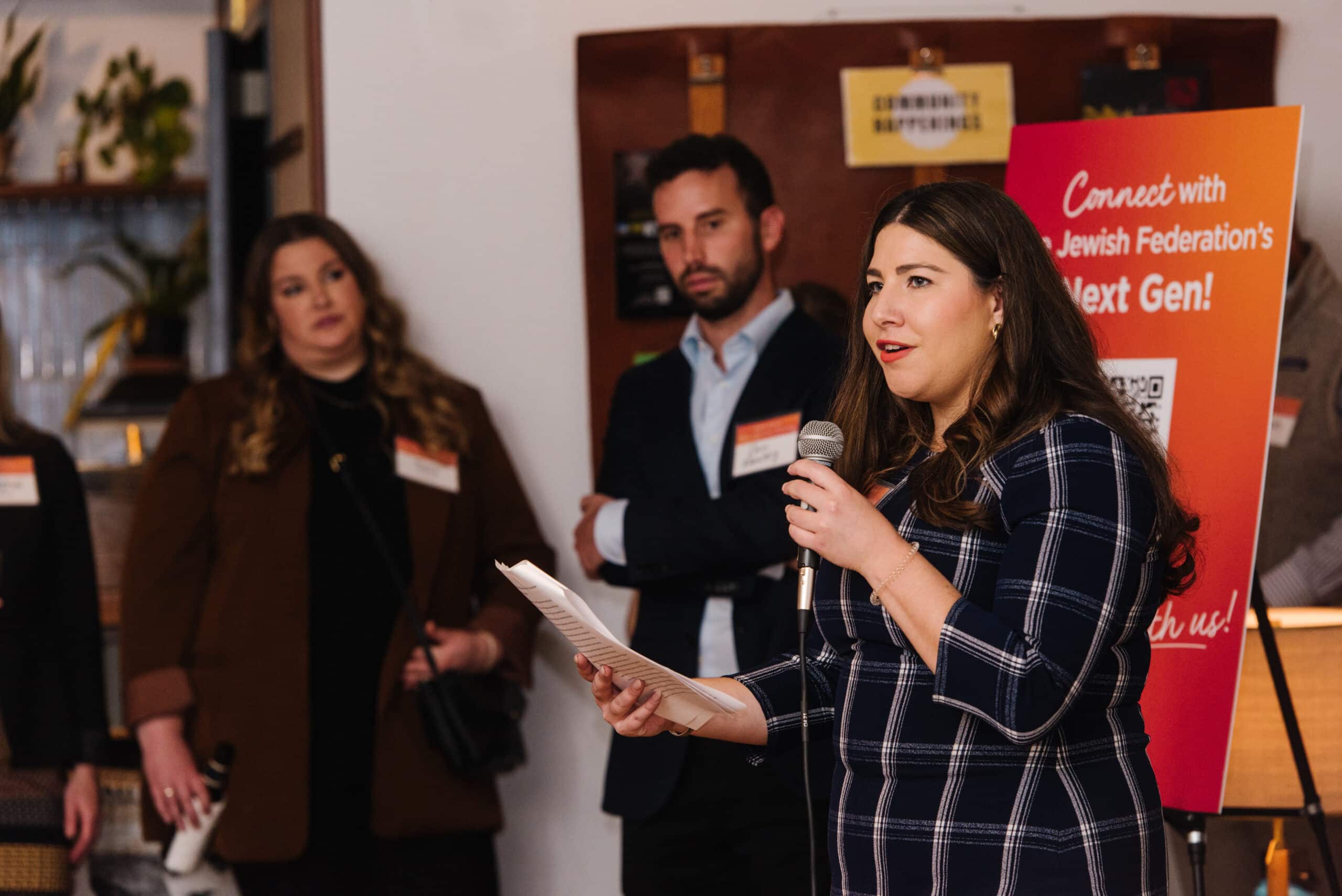 Group of people speaking at event.