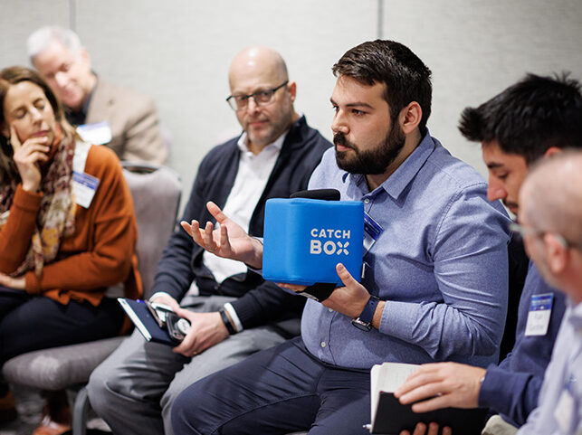 Person holding a box labeled 