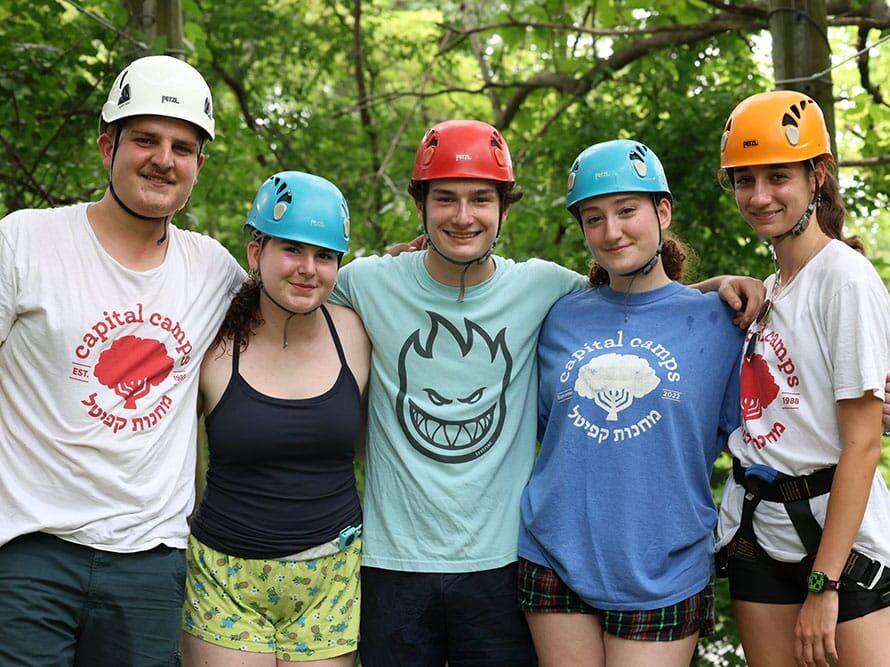 A group of teens wearing helmets at summer camp