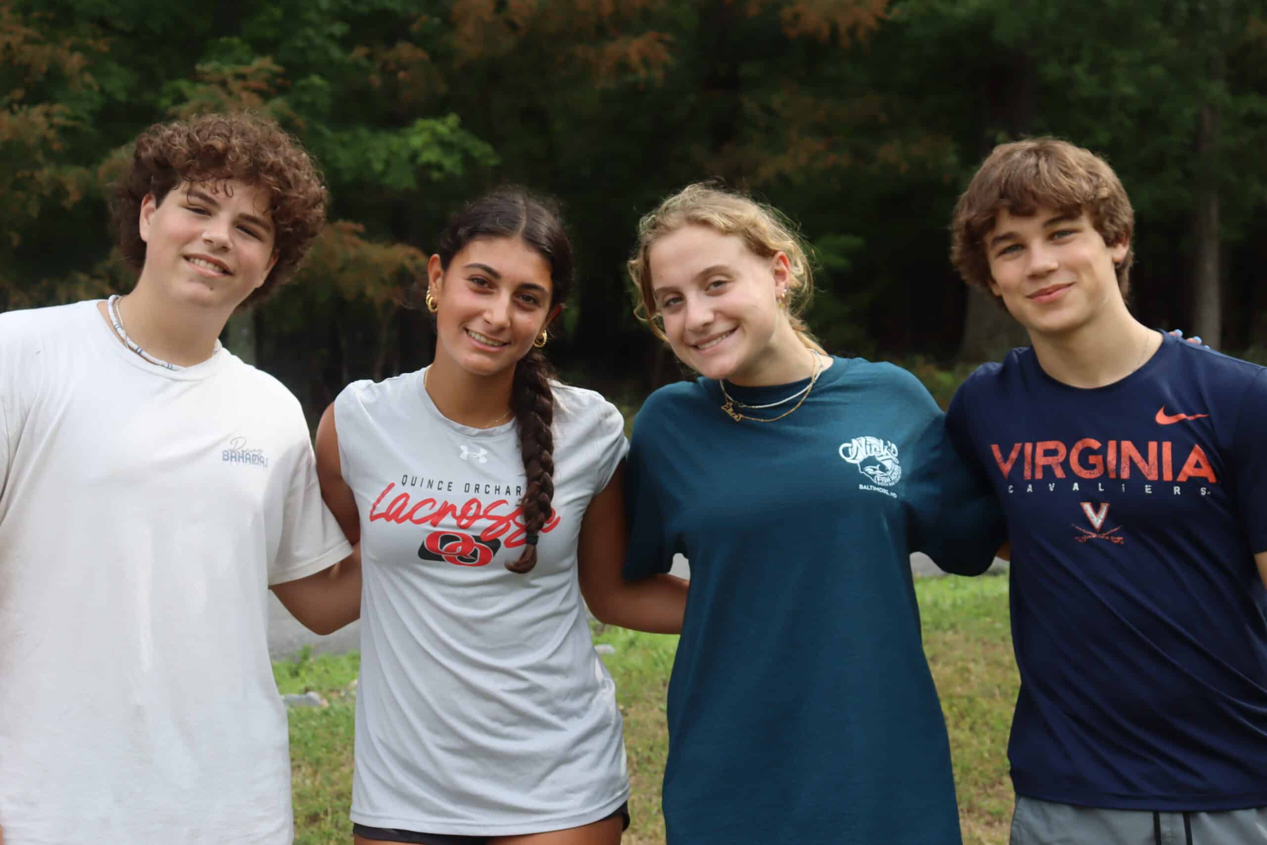 Teens at camp, smiling at camera.