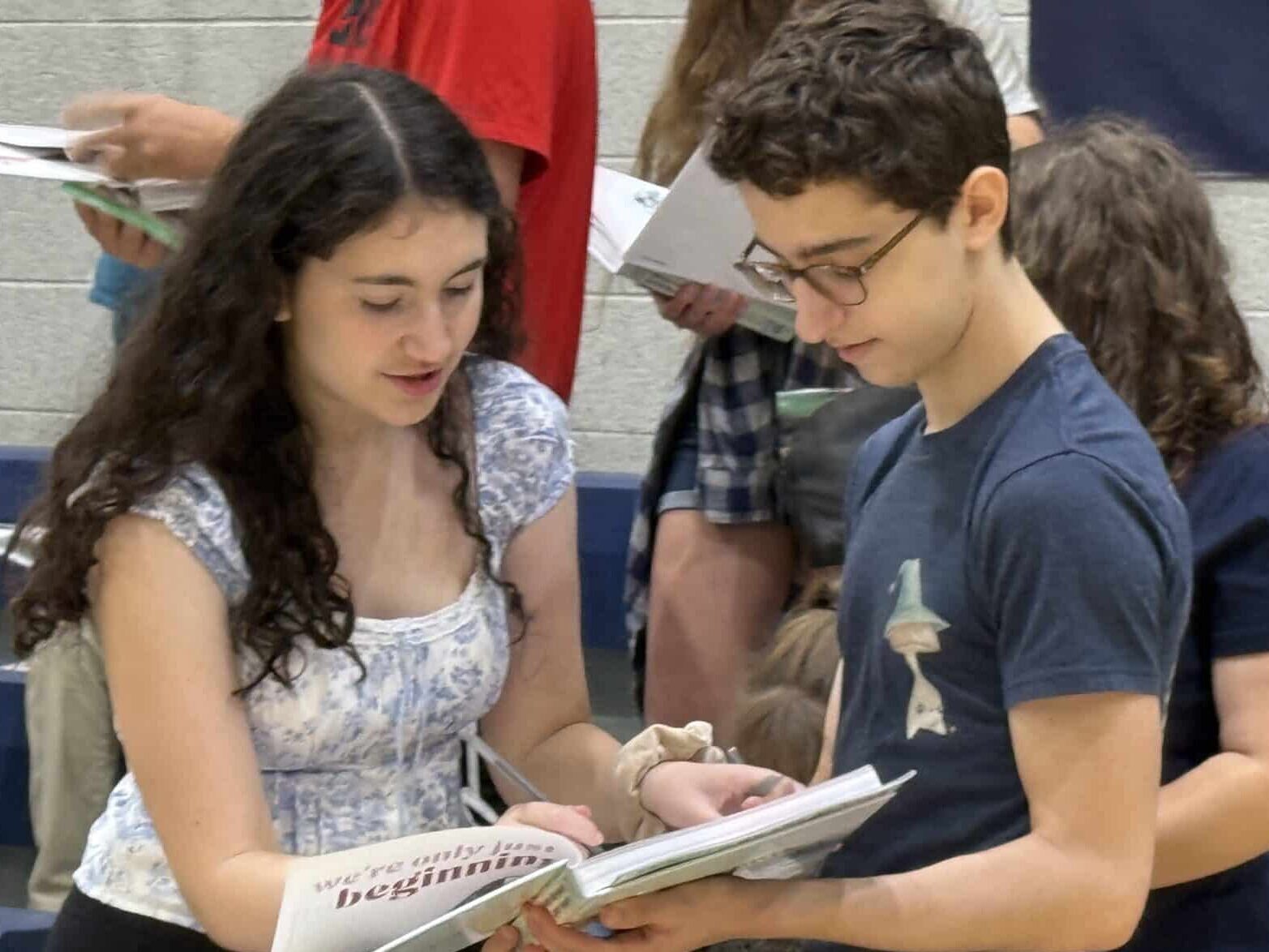 Students reading a book.