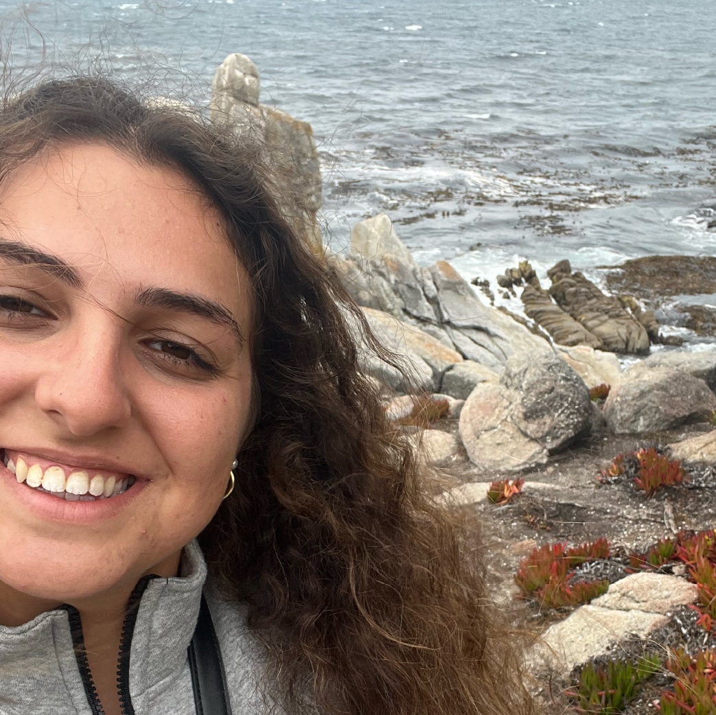 A headshot of a woman at the beach