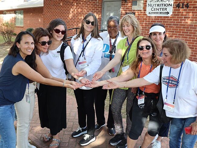 A group of women putting their hands together