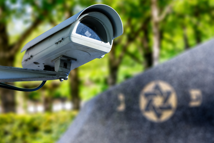 Security camera with star of David on background. Concept of monitoring religious buildings of the Jewish faith