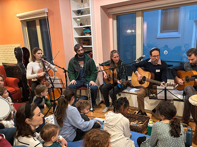 Group of people playing guitars.
