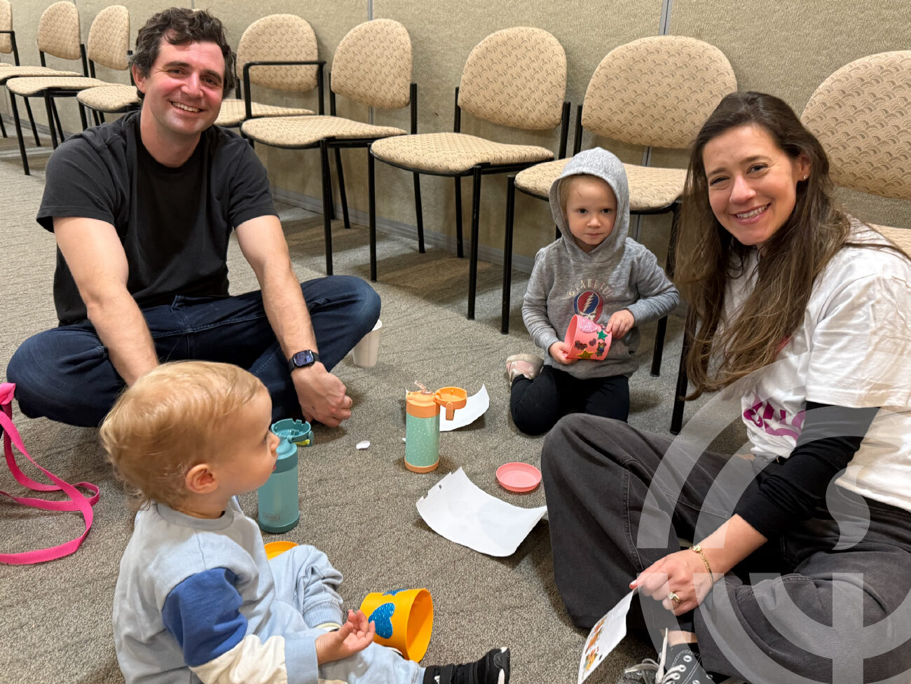Family with young children doing craft together