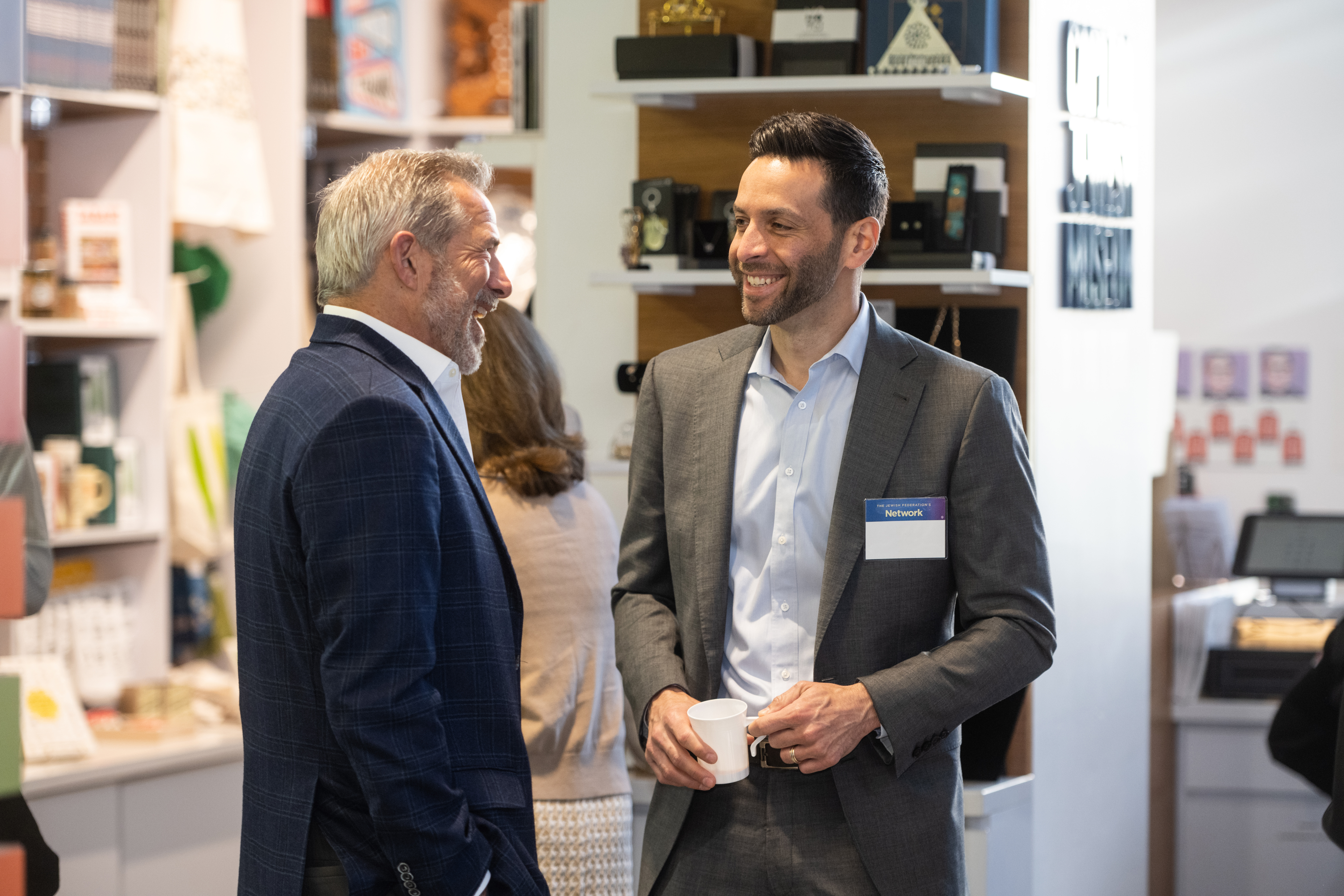 Two men speaking at The Network's Real Estate Division Breakfast at the Capital Jewish Musuem